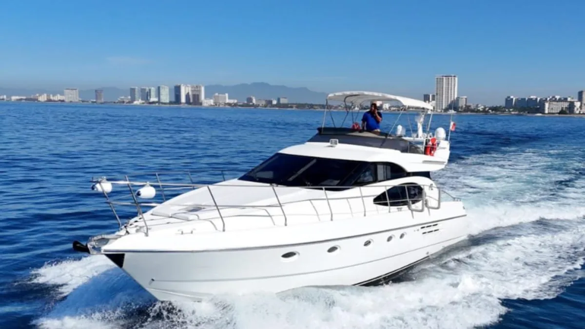 An Azimut 52 motor yacht running past the Puerto Vallarta hotel zone on an owner-direct charter