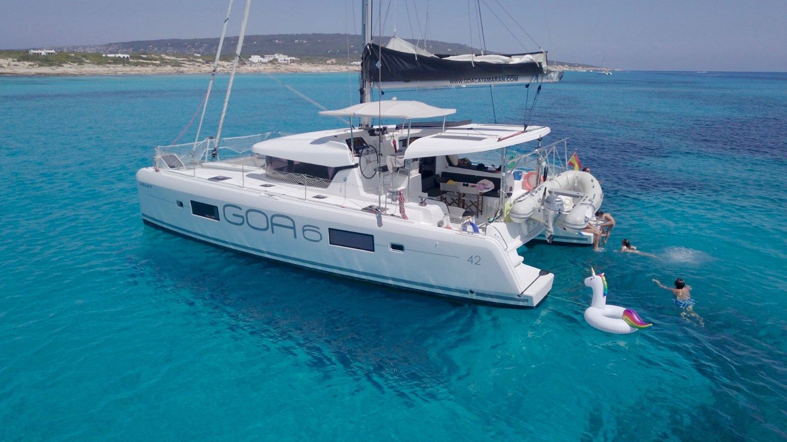 Guests swimming beside a Lagoon 42 catamaran anchored in clear water off La Cruz de Huanacaxtle