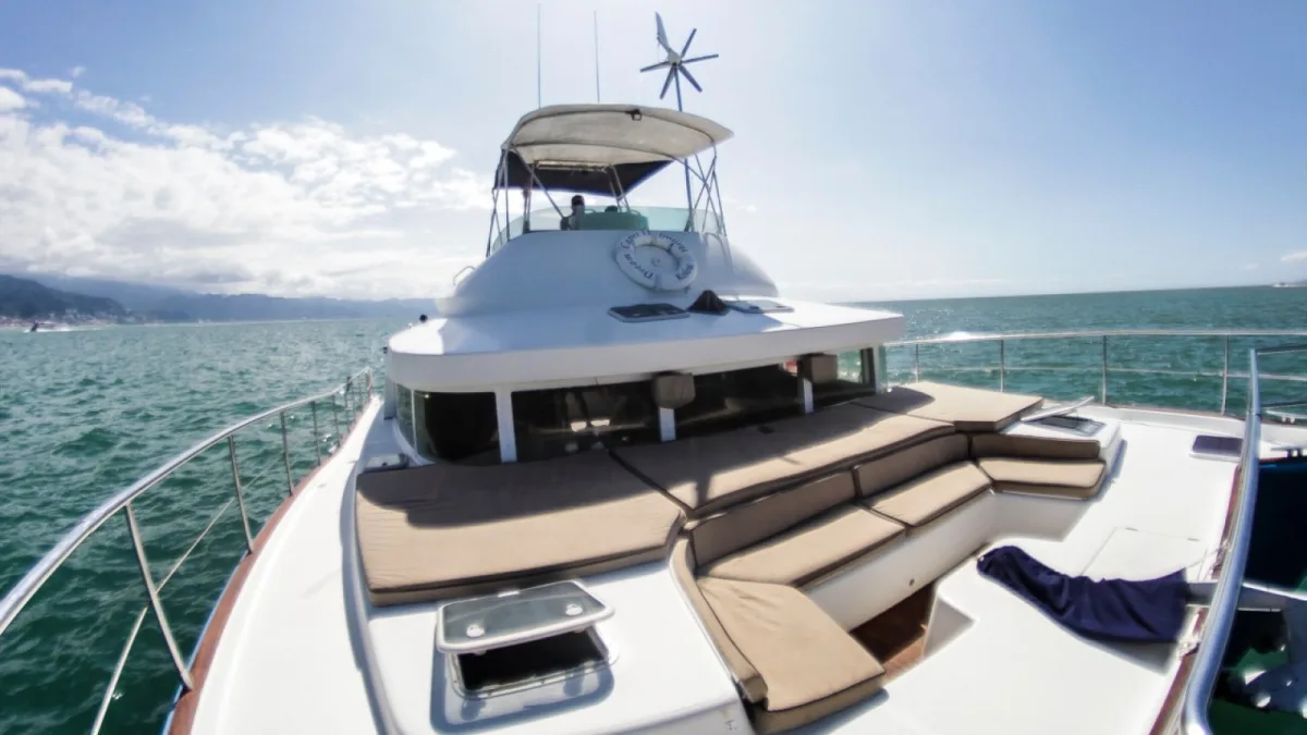 The foredeck sun pads of the 43 ft Lagoon power catamaran with the Puerto Vallarta coast behind
