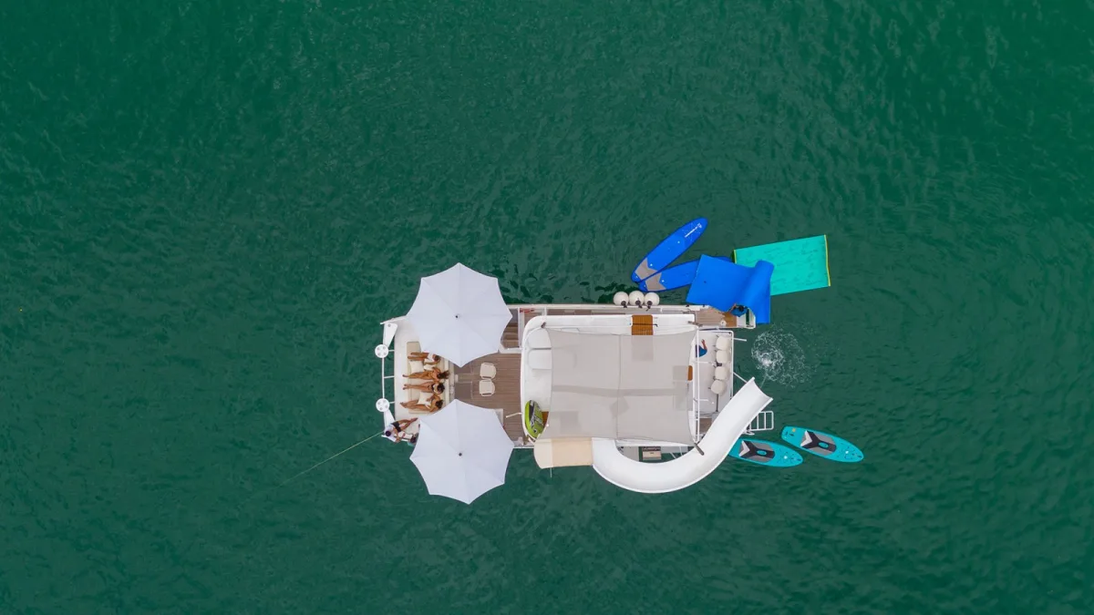 Aerial view of the 45 ft party catamaran with its waterslide and floating mats deployed off Puerto Vallarta