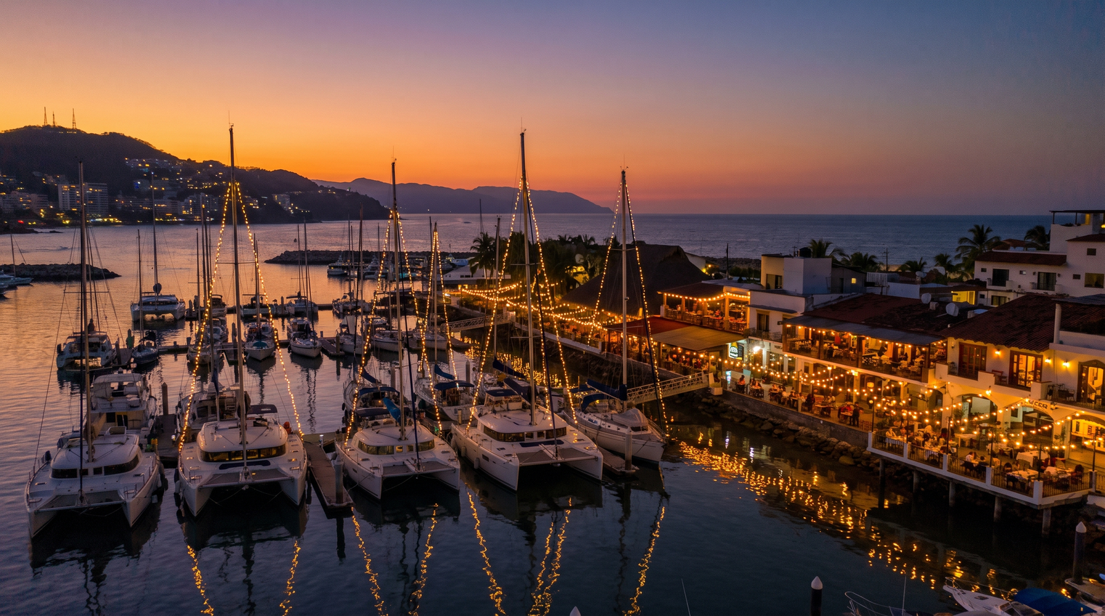 Marina Vallarta waterfront condos and yachts at golden hour, a popular zone for foreign property buyers in Puerto Vallarta